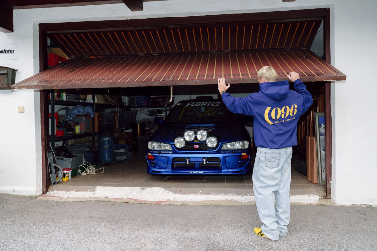 096 Hoodie at the garage with the rally Impreza